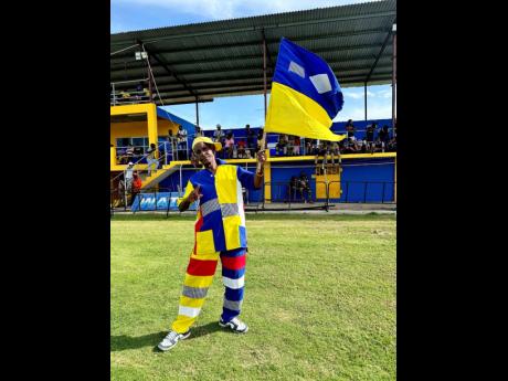 Credit: Ashley Anguin Richard ‘Clown’ Honeywell, St Elizabeth Technical High School (STETHS) mascot for 55 years, posing during STETHS’ WATA ISSA daCosta Cup football match against B.B. Coke High at the STETHS on Tuesday.
