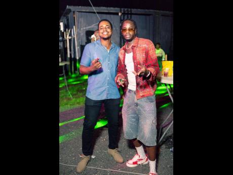 Brandon Wallace (left), Magnum Tonic Wine brand manager, extends a personal birthday greeting to dancehall star Ding Dong before he hits the stage.