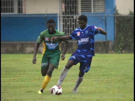 Credit: Ashley Anguin Jordon Grey (left) of The Manning’s School competes with Donnovan Parchment of Grange Hill High during their Zone C match in the ISSA/WATA daCosta Cup at Manning’s yesterday. Manning’s won 5-0