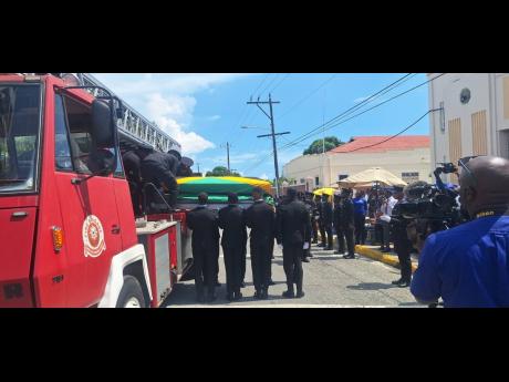 Credit: Tiffany Taylor Photos The body of firefighter Shamar Myrie is carried into the North Street Seventh-day Adventist Church in Kingston yesterday for the thanksgiving ceremony.