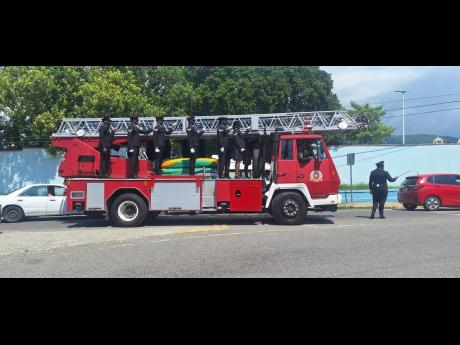 Credit: Tiffany Taylor Colleagues of slain fireman Shamar Myrie transport his body to the church.