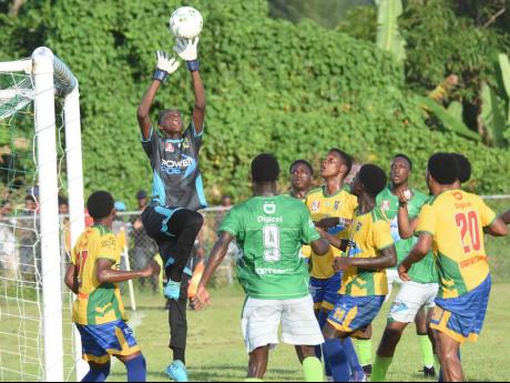 Credit: Ashley Anguin Rusea’s High’s goalkeeper Sadrick Antoine jumps highest to make a save during the Zone B ISSA/WATA daCosta Cup match at the Collin Miller Sports Complex in Lucea, Hanover yesterday.