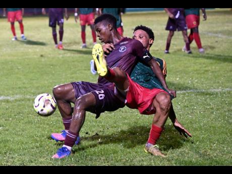Credit: Rudolph Brown Nathaniel Howe (left) of Chapelton Maroons is tackled from behind by Humble Lion’s Javon Smith during the Jamaica Premier League football match at Anthony Spaulding Sports Complex yesterday. Chapelton Maroons won 2-0.