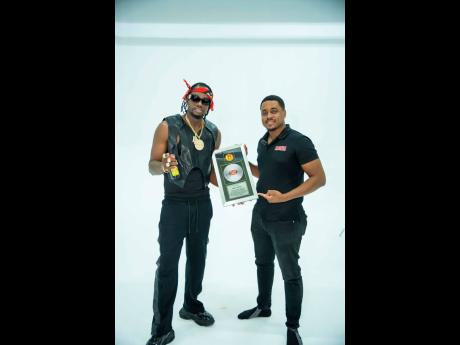 Credit: Contributed Dancehall sensation Ding Dong (left) receives his plaque from Magnum Tonic Wine’s Brand Manager, Brandon Wallace, as part of the brand’s 25th anniversary celebrations, honouring key figures in the dancehall community.