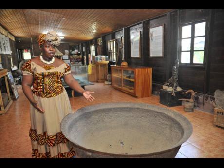 Credit: FILE Douglas sharing the history and use of a copper pot inside the Charles Town museum.