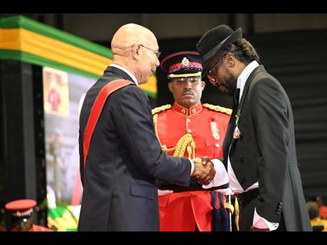 Credit: Rudolph Brown Governor General Sir Patrick Allen presents the Order of Distinction in the rank of Officer to Moses ‘Beenie Man’ Davis.