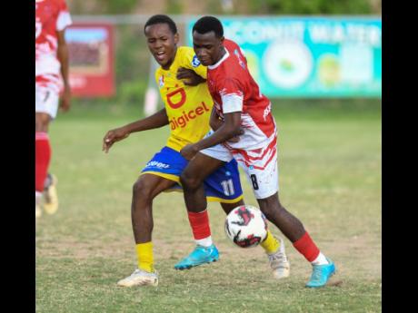 Elijah Whyte of Campion College (right) battles with Andrew Anderson of Jose Marti for the ball during the ISSA Manning Cup football match on October 12 at Campion College.