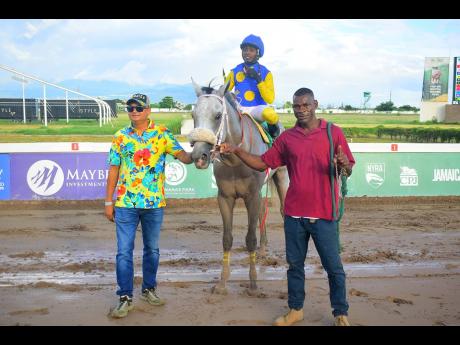 Credit: Anthony Minott MOJITO, with Dane Dawkins aboard and flanked by connections, parading after winning the Kaz Hoshay Trophy over six furlongs at Caymanas Park on Saturday. The open allowance event was contested by three-year-olds and upwards. Dawkins scored a three-timer on the 11-race card.