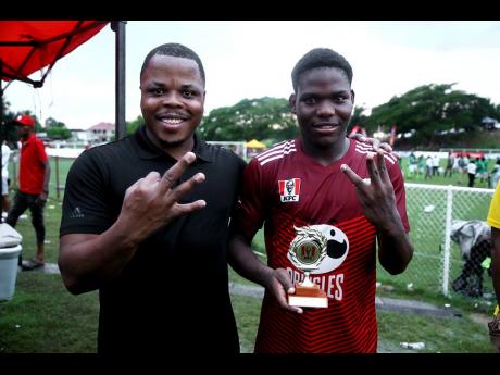 Credit: Nathaniel Stewart Glenmuir High's head coach Andrew Peart (left) with Orane Watson, the player of the match who scored in the 47th, 64th and 79th minutes for Glenmuir to defeat Frome Technical 4-3 after going into the half time 1-3 in their ISSA/WATA daCosta Cup quarterfinal football match at Glenmuir High School on Saturday.