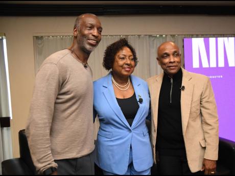 Credit: Matthew McKoy Legendary United States sprinter Michael Johnson (left), head of Grand Slam Track, Olivia ‘Babsy’ Grange, minister of culture, gender, entertainment and sport, and Christopher Samuda (right), president of the Jamaica Olympic Association, stand together during a press conference to announce details of The Grand Slam Track League at The Jamaica Pegasus hotel in New Kingston yesterday.