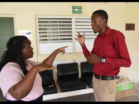 Credit: Ian Allen Ka Vaughne Brown (right) communicates with Keshana Smith-Hurditt.