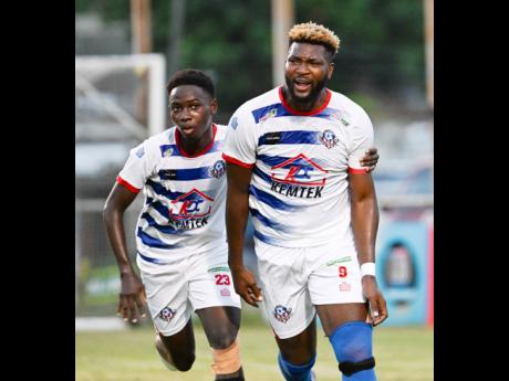 Portmore United’s Chevaughn Walsh (right) is congratulated ny teammate Okelo Howard after scoring against Arnett Gardens on Sunday, March 31.