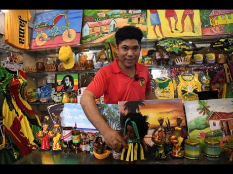 Credit: Antoine Lodge Marcelino Chang, vendor in the Kingston Craft Market, says souvenirs are a big hit with tourists.