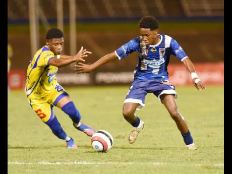 Credit: Ian Allen Jahmarly Bennett (right) from Jamaica College and Rasheem Green of HydelHhigh School compete for the ball during their Champions Cup Knockout football match at the National Stadium. Both schools will be involved in Manning Cup semi-final action today.