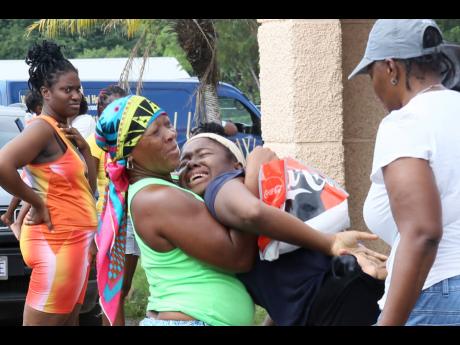 Credit: Nathaniel Stewart Kristina Mattis (centre) is comforted by relatives after receiving news that her friend perished in the crash.