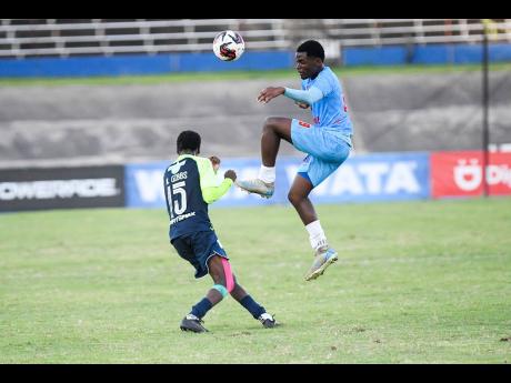 Credit: Matthew McKoy Tchane Riley (right) of St Catherine High School jumps above Nashordo Gibbs of Jamaica College to head the ball during the ISSA Manning Cup semi-final at the National Stadium on Tuesday. St Catherine won 5-3 on penalties, following 1-1 draw.