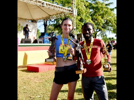 Credit: Ashley Anguin London’s Rosamund Ponder (left) and Jamaica’s Kemar Leslie celebrate winning the respective women’s and men’s half marathon segments in the Reggae Marathon in Negril, Westmoreland, yesterday.