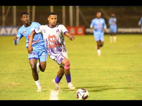 Credit: Matthew Mckoy Rajae Ximines (right) of Kingston College