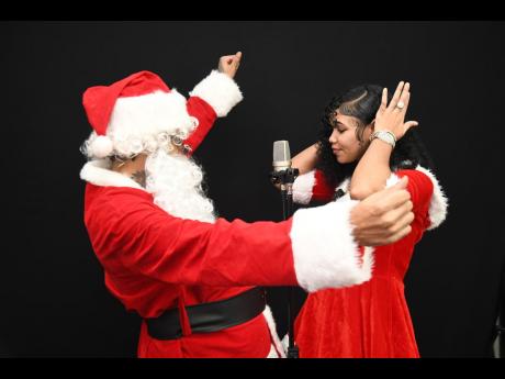 Recording artistes Gold Gad, dressed as Santa Claus, and Mehkadon, as Mrs Claus, promoting their new single, ‘Christmas Wish’.