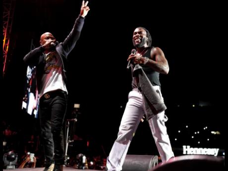 Credit: File Serani (left) on stage with Burna Boy at Burner Boy Live held at National Stadium in Kingston on December 19, 2022.