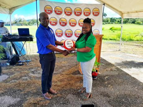 Tricia Robinson (right), president of Netball Jamaica, presents Dr Garth Sommerville, chairman of Netball Hanover, with a new netball at the recent launch of Netball Hanover, the new parent body for netball in that western parish.