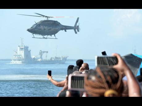 Credit: Rudolph Brown Spectators capture the opening of the Exercise Event Horizon 2025 as Jamaica Defence Force Coast Guard and Air Wing personnel do their manoeuvres.
