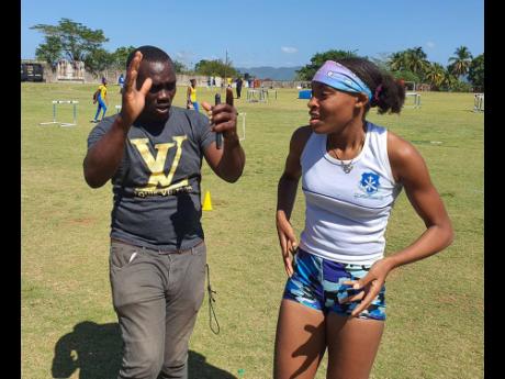 Credit: File Photos Mount Alvernia High School’s coach Andrew Henry demonstrating the ideal technique for his Class One long jumper Aaliyah Foster at Western Champs at G.C. Foster College of Physical Education and Sport in February 2023.