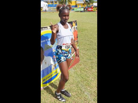 Credit: File Giana Murray celebrating on the grass track at St Elizabeth Technical High School after winning the Class Four 100 metres at Western Champs in February, 2024.