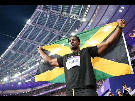 Roje Stona of Jamaica celebrates an Olympic record-breaking gold in the men’s discus finals at the Stade de France in Paris, France on Wednesday, August 7, 2024.