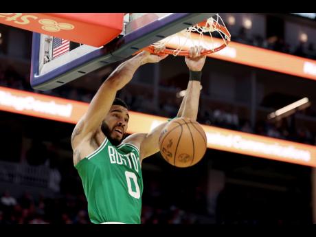 Credit: AP Boston Celtics forward Jayson Tatum (0) dunks the ball during the first half of an NBA basketball game against the Golden State Warriors in San Francisco yesterday. The Celtics won 125-85.