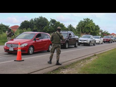Credit: FILE A member of the Jamaica Defence Force manning a SOE checkpoint.
