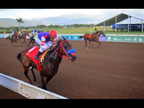 Credit: Anthony Minott BOOTYLICIOUS, running against the stands side and ridden by Ismael Velasque, winning the Reggae Month Trophy over five furlongs straight at Caymanas Park on Saturday.