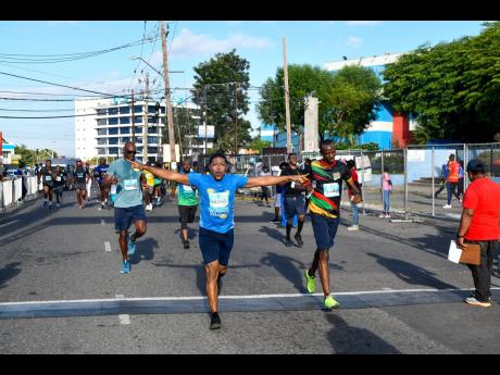 Participants cross the finish line after completing the 5K event.