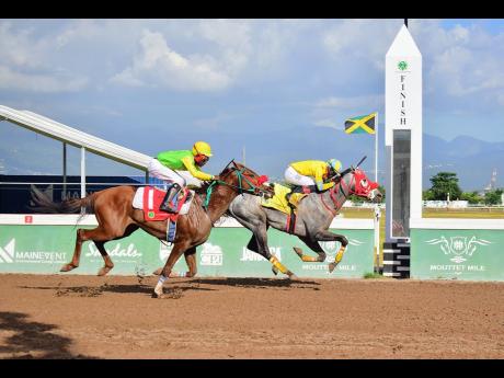 Credit: Anthony Minott MONEY MUST (right), ridden by Phillip Parchment, winning the seventh race ahead of DOUBLE THE CASH, with T.Suckoo abaord, over five furlongs round at Caymanas Park on Sunday.