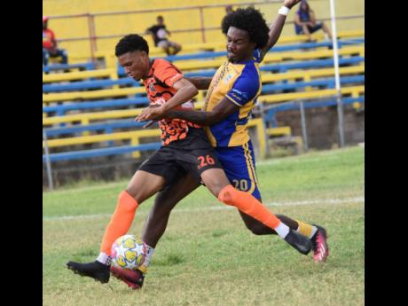 Roshawn Oldfield (left) of Tivoli Gardens is tackled by Luka Kung of Harbour View during their Jamaica Premier League football match at Harbour View Mini Stadium yesterday. The game ended 2-2.