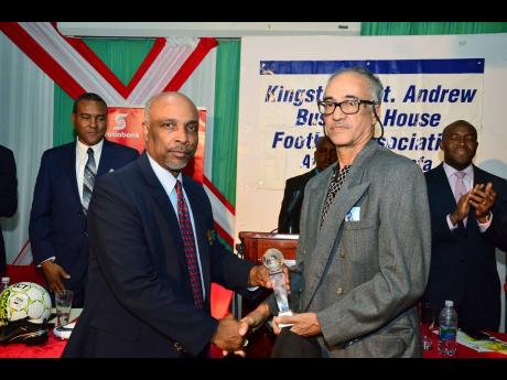 Christopher Samuda (left), president of Jamaica Olympic Association presenting the President’s Award to Geoffrey Maxwell for outstanding service to football as a player and a coach in Jamaica.