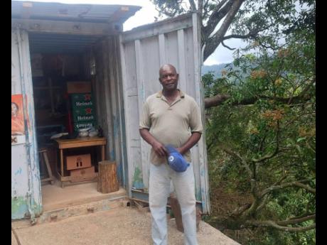 Credit: Almando Smith Ezra Willis stands outside his shop in McGlaushin, rural St Andrew.