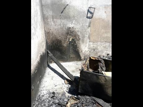 Credit: Ashanti Lawson The burnt-out home where Olganese Chambers-Taylor died in her living room on March Pen Road, Spanish Town, St Catherine.