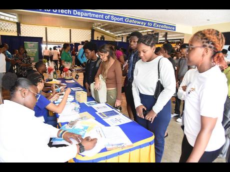 Credit: Ian Allen Students at the University of Technology interact with industry professionals during the employment and Internship fair at the Papine campus last Friday.