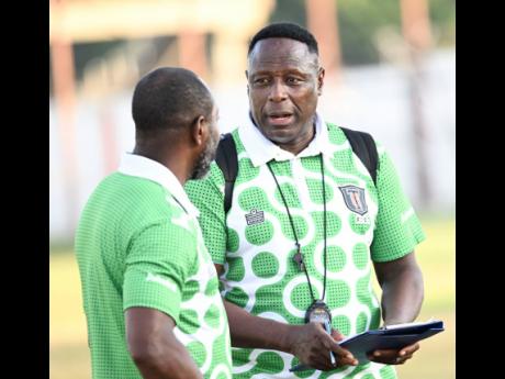 Tivoli Gardens head coach Jerome Waite (right) discusses tactics with assistant coach Phillip Williams during Sunday’s Jamaica Premier League match against Waterhouse at the Edward Seaga Sports Complex. 
