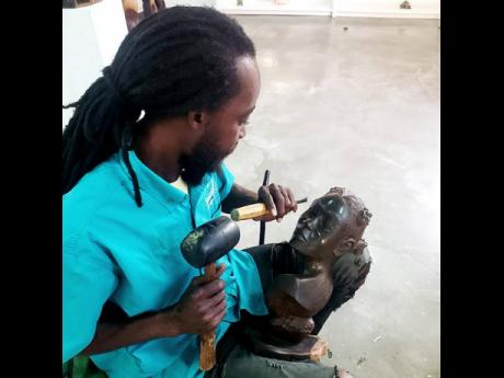 Credit: Contributed Photos Henry working on a piece.