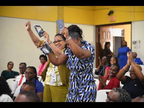 Credit: Antoine Lodge Andrea Hitchener (left), acting principal, and Andrine Morris, business teacher, both at Immaculate Conception High School, are in celebration mode after their colleague Shanique Pryce was declared Mathematics Teacher of the Year.