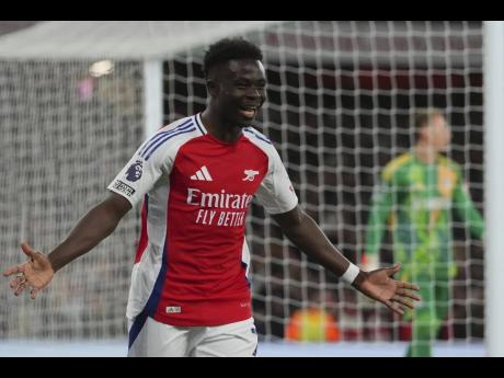 Credit: AP Arsenal’s Bukayo Saka celebrates after scoring his side’s second goal during the English Premier League match between Arsenal and Fulham at Emirates stadium in London, yesterday.