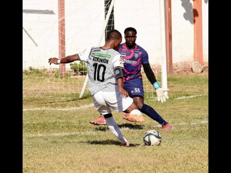 Credit: Ian Allen/Photographer Dwayne Atkinson (left) of Cavalier S.C. gets a clear scoring opportunity against Tivoli Gardens’ goalkeeper Diego Haughton during their Jamaica Premier League football match at Edward Seaga Sports Complex on Thursday. The game ended 1-1.