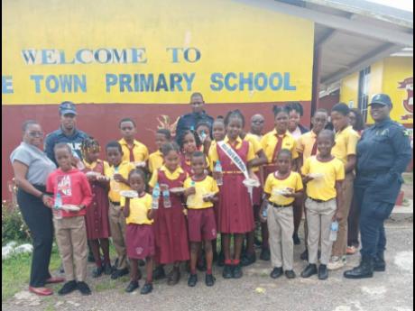 Credit: Rasbert Turner Police personnel from The Guys Hill police station yesterday at the Jubilee Town Primary School donating bun and cheese