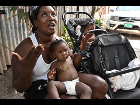 Credit: Rudolph Brown Sydonie Higgins is now left to take care of her one-year-old twin daughters after their father, Shaquille Dawkins, was shot and killed at 100 Lane on Friday.