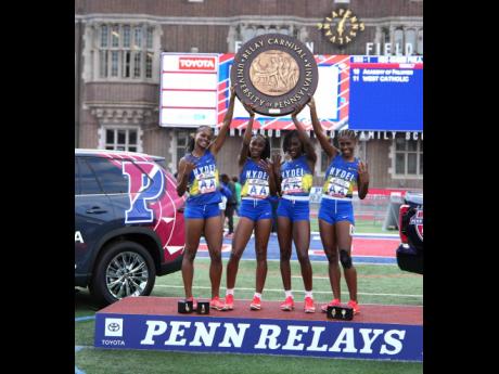 From left: Hydel High School’s Abigail Campbell, Nastassia Fletcher, Sashana Johnson, and Jody Ann Daley hold aloft the Penn Relays shield they earned from winning the Championship of America 4x400-metre relay at the Franklin Field Stadium in Philadephia, Pennsylvania, on Saturday.