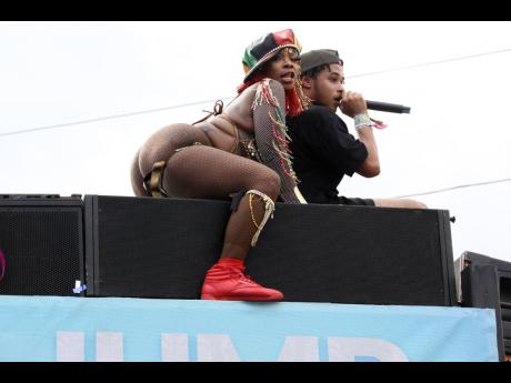 Credit: Nathaniel Stewart Photos Dancehall artiste Pamputtae (left) and a DJ atop a Yardmas truck during Carnival Road March on Sunday.
