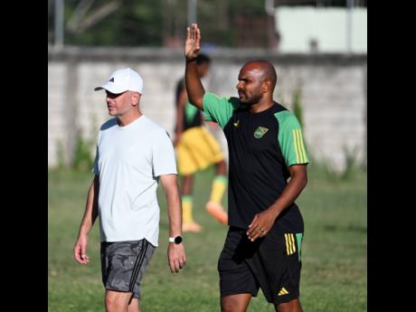 Portmore United’s head coach Rodolph Austin (right) conducting a national under-20 training session.