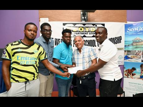 Credit: Ashley Anguin Anthony Pearson (second right), managing director, Lloyd’s Department Store, presents a sponsorship cheque to (from left) Ryan Wright, coach, St Mary’s Prep, Duwayne Webb, coach, Williams Elite Academy, Obryan Falconer, coach, Eber Prep and Andrew Henry, competition’s director, during the launch of the Western Prep School Championships at Mount Alvernia High School on Tuesday.